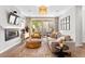 Open living room featuring a cozy seating area, modern fireplace, and access to the outdoor patio at 3885 Vrain St, Denver, CO 80212