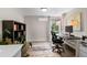 Bright office space with dark hardwood floors, built-in shelving, and a large window at 3885 Vrain St, Denver, CO 80212