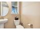 Cozy half bath featuring a pedestal sink and modern fixtures at 7265 S Millbrook Ct, Aurora, CO 80016