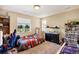 A cozy bedroom with a large window, featuring unique decor, gaming chair, and a large aquarium at 7265 S Millbrook Ct, Aurora, CO 80016