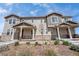 Attractive townhome featuring stone accents, covered porch, and low maintenance landscaping at 7265 S Millbrook Ct, Aurora, CO 80016