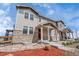 Charming townhome exterior with stone accents, covered front porch, and beautifully landscaped front yard at 7265 S Millbrook Ct, Aurora, CO 80016