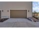 Attached one car garage with neutral door on home with horizontal siding and exterior coach lighting at 7265 S Millbrook Ct, Aurora, CO 80016