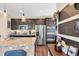 Modern kitchen with stainless steel appliances, granite countertops, and dark wood cabinets at 7265 S Millbrook Ct, Aurora, CO 80016