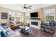 Comfortable living room with hardwood floors, a cozy fireplace, and backyard views at 7265 S Millbrook Ct, Aurora, CO 80016