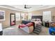 Spacious primary bedroom with a tray ceiling, plush carpet, and large windows at 7265 S Millbrook Ct, Aurora, CO 80016