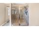 Modern glass-enclosed shower with tiled walls and a shower head offering a clean and contemporary design at 7265 S Millbrook Ct, Aurora, CO 80016