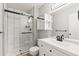 Modern bathroom featuring a glass shower, updated vanity, black hardware and shelving at 12893 W Alameda Dr, Lakewood, CO 80228