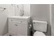 Bathroom features an updated vanity with modern finishes and a toilet at 12893 W Alameda Dr, Lakewood, CO 80228