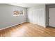 Spacious bedroom featuring hardwood floors, a bright window, and ample closet storage at 12893 W Alameda Dr, Lakewood, CO 80228