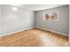 Bright bedroom with laminate floors, neutral walls, window and white trim at 12893 W Alameda Dr, Lakewood, CO 80228