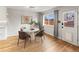 Bright dining room with hardwood floors, stylish table and chairs, and backyard view at 12893 W Alameda Dr, Lakewood, CO 80228