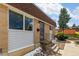 Home's entrance features a decorative security door, brick facade, and small landscaped area at 12893 W Alameda Dr, Lakewood, CO 80228