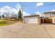 View of a detached garage with parking spot and play area at 12893 W Alameda Dr, Lakewood, CO 80228