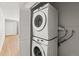 Efficient laundry area featuring stacked washer and dryer units, maximizing space and convenience for homeowners at 12893 W Alameda Dr, Lakewood, CO 80228