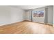 Bright living room with hardwood floors, large windows and a door at 12893 W Alameda Dr, Lakewood, CO 80228