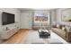 Bright living room with hardwood floors, large windows, and modern furnishings at 12893 W Alameda Dr, Lakewood, CO 80228