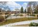 Inviting fenced community pool surrounded by trees and landscaping with nearby residential buildings at 12893 W Alameda Dr, Lakewood, CO 80228