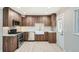 Well-lit kitchen featuring stainless steel appliances, sleek wood-tone cabinets, and subway tile backsplash at 1330 E 90Th Ave, Thornton, CO 80229