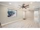 Bright living room with light wood floors, modern ceiling fan, and plenty of natural light at 1330 E 90Th Ave, Thornton, CO 80229