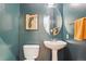 Cozy powder room features pedestal sink, decorative mirror, and framed lake map at 2960 Inca St # 116, Denver, CO 80202