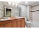 Well-lit bathroom featuring double vanity, shower-tub combo, and modern fixtures at 2960 Inca St # 116, Denver, CO 80202