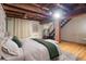 Bright bedroom with exposed wood beam ceilings and wood flooring throughout at 2960 Inca St # 116, Denver, CO 80202