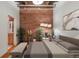 Bedroom with exposed brick, modern lighting, and decorative plants on display at 2960 Inca St # 116, Denver, CO 80202