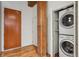 Convenient laundry area with stacked washer and dryer, plus storage shelves at 2960 Inca St # 116, Denver, CO 80202