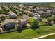 Aerial view showcasing neighborhood with lush green space, fenced yards, mature trees, and homes at 18554 E Vassar Dr, Aurora, CO 80013