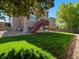 Backyard view featuring a well-maintained lawn, mature tree, and two-story home at 18554 E Vassar Dr, Aurora, CO 80013