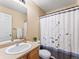 Bright bathroom featuring a shower-tub combo, neutral walls, and stylish shower curtain at 18554 E Vassar Dr, Aurora, CO 80013