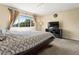 Bedroom featuring a comfortable bed, large window and TV at 18554 E Vassar Dr, Aurora, CO 80013