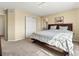 Bedroom features a comfortable bed, closet, ensuite bathroom, and TV at 18554 E Vassar Dr, Aurora, CO 80013