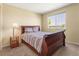Bedroom featuring a comfortable bed, side table, and large window at 18554 E Vassar Dr, Aurora, CO 80013