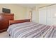 Bedroom featuring a comfortable bed, dresser, closet and large window at 18554 E Vassar Dr, Aurora, CO 80013