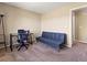 Bedroom with large window, neutral walls, and a cozy sitting area with comfortable futon at 18554 E Vassar Dr, Aurora, CO 80013