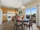 Bright dining area with a glass table, modern chairs, and sliding doors to an outdoor space at 18554 E Vassar Dr, Aurora, CO 80013