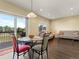 Bright and airy dining space with access to an outdoor deck and view into the living area at 18554 E Vassar Dr, Aurora, CO 80013