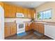 Efficient kitchen with wood cabinets and a window offers natural light at 18554 E Vassar Dr, Aurora, CO 80013