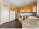 Well-lit kitchen features ample cabinets, a bright white refrigerator, and stainless sink at 18554 E Vassar Dr, Aurora, CO 80013
