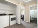 A laundry room with a washer and dryer and an open doorway at 18554 E Vassar Dr, Aurora, CO 80013