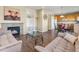 Inviting living room showcases a fireplace, stylish furniture, and seamless flow to the kitchen at 18554 E Vassar Dr, Aurora, CO 80013