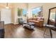 Cozy living room features soaring ceilings, hardwood floors, and large windows for natural light at 18554 E Vassar Dr, Aurora, CO 80013