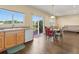 Open-concept living room with natural light, dining area, and walk-out to deck at 18554 E Vassar Dr, Aurora, CO 80013