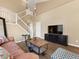 Cozy living room features soaring ceilings, hardwood floors, and large windows for natural light at 18554 E Vassar Dr, Aurora, CO 80013