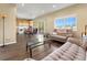 Open-concept living area with wood floors, couches, and a view of the kitchen and dining area at 18554 E Vassar Dr, Aurora, CO 80013