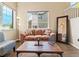 Cozy living room features soaring ceilings, hardwood floors, and large windows for natural light at 18554 E Vassar Dr, Aurora, CO 80013