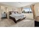 Bright main bedroom features a large window and an ensuite bathroom at 18554 E Vassar Dr, Aurora, CO 80013