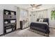 Cozy bedroom with a full-size bed and built-in shelving at 5760 S Geneva St, Greenwood Village, CO 80111